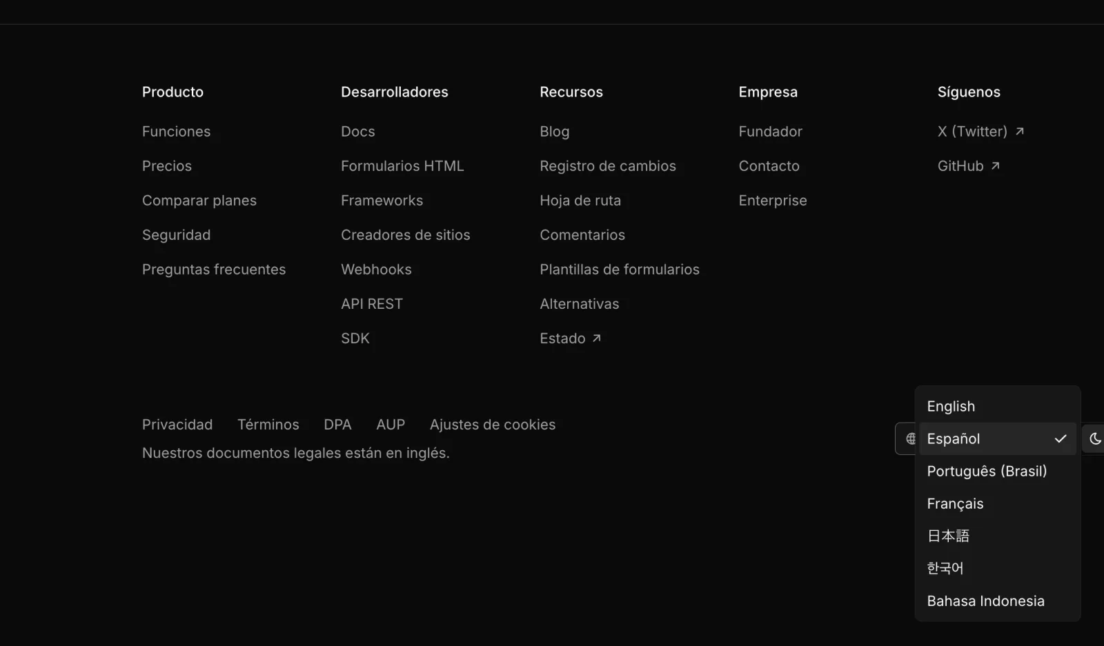 The site footer in Spanish with the language menu open, listing all seven languages.